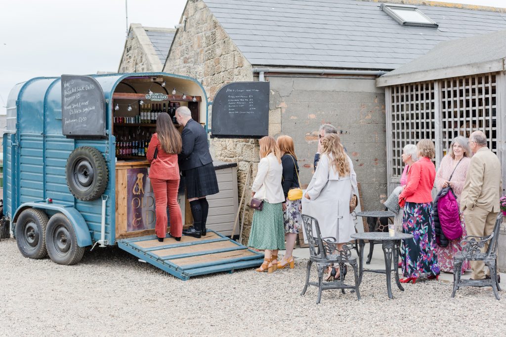 guests waiting at festival horse box bar