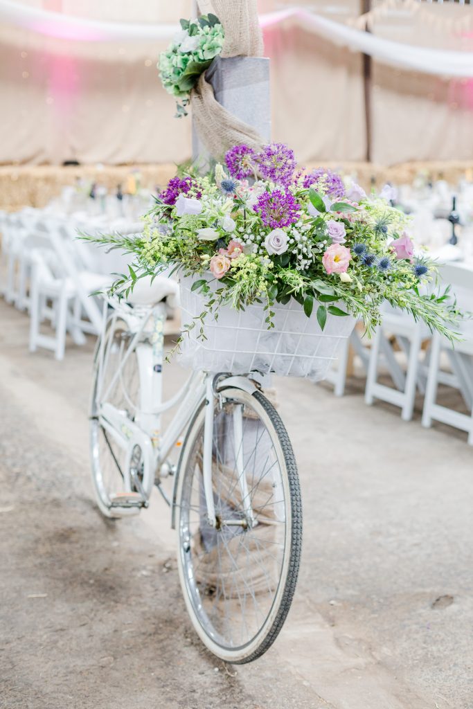 white vintage bike with flower display in basket