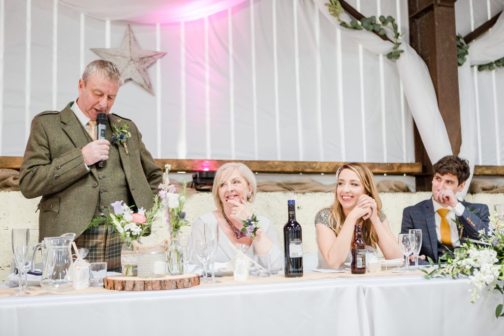 top table listening to speech by father of bride