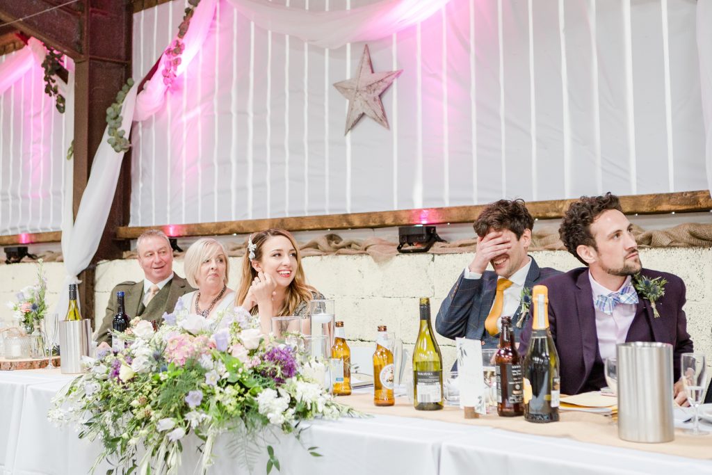 top table listening to speech by groomsmen