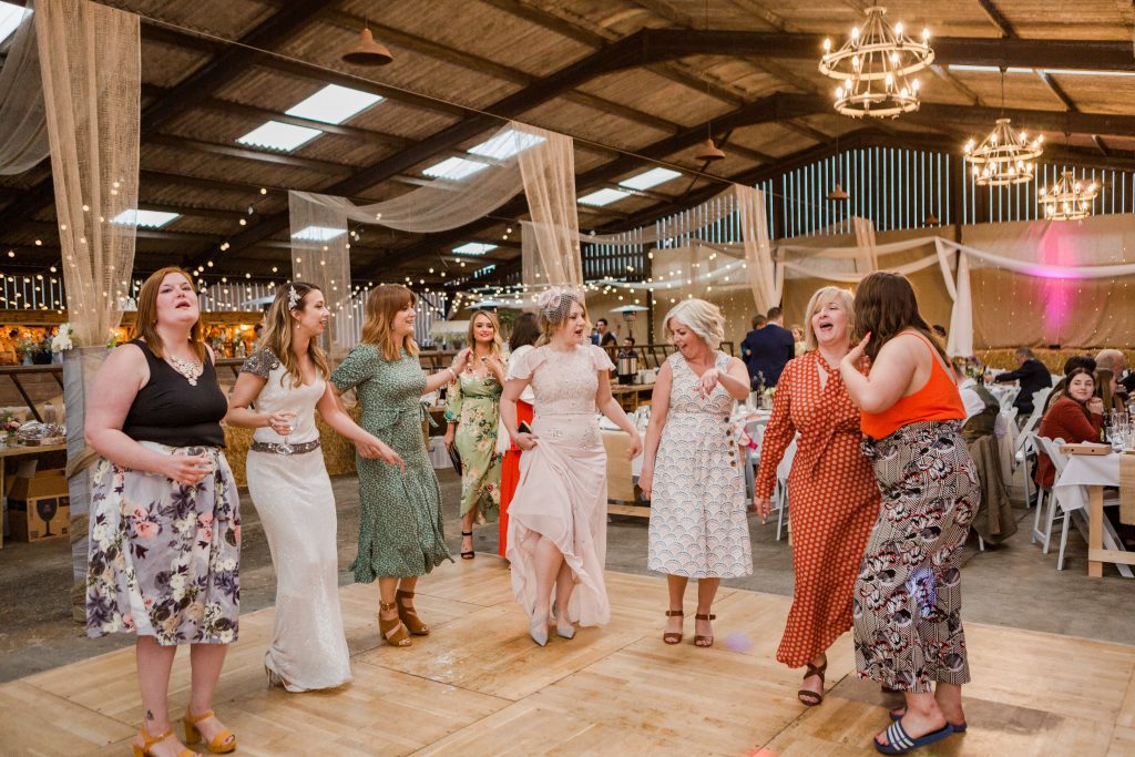 bride and wedding guests dancing on festival wedding dance floor