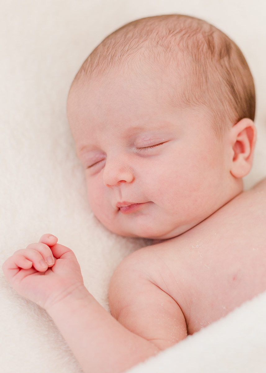 newborn asleep on back close up of face