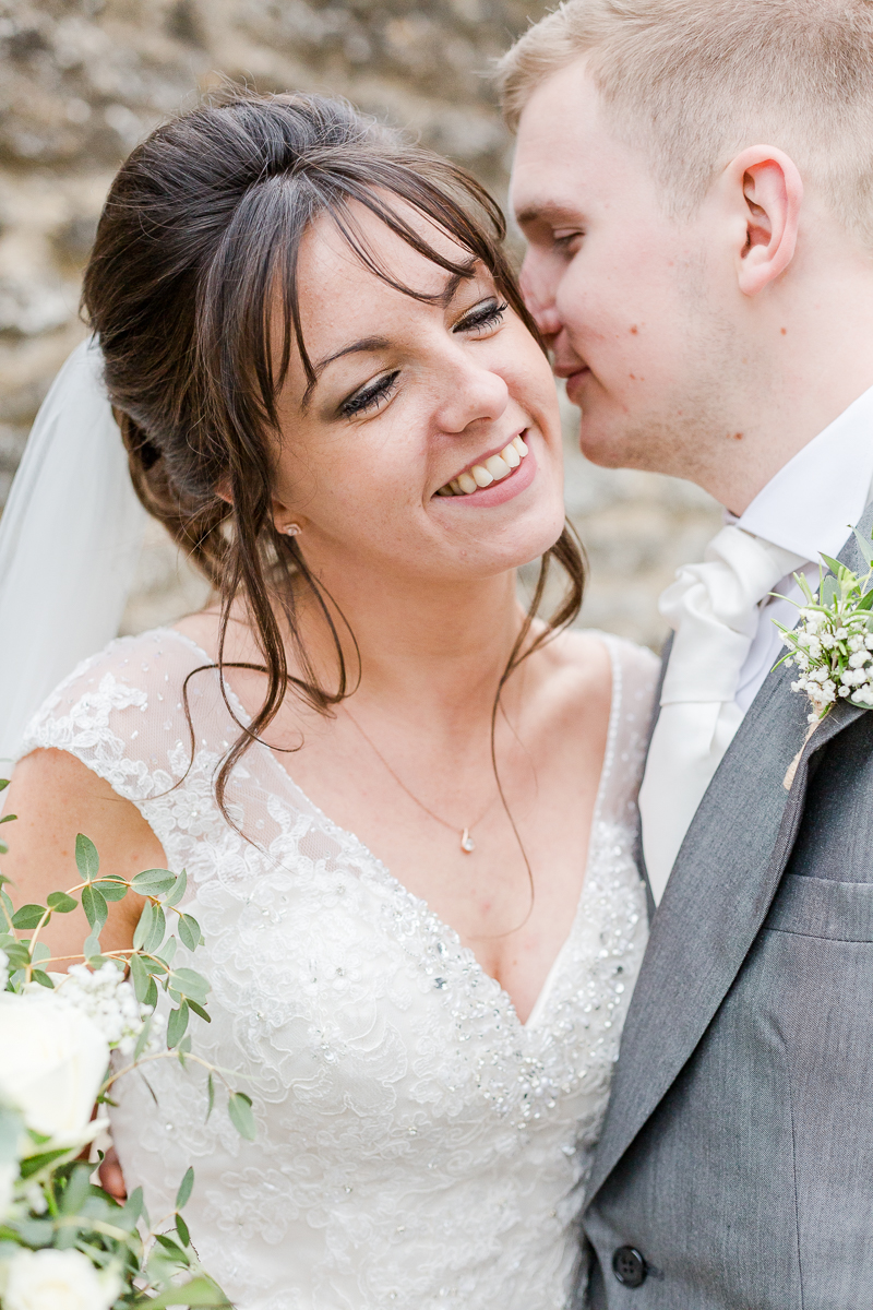 groom whispering into brides ear