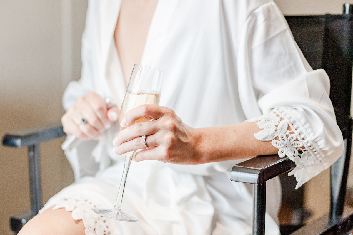 brides hand holding champaign glass