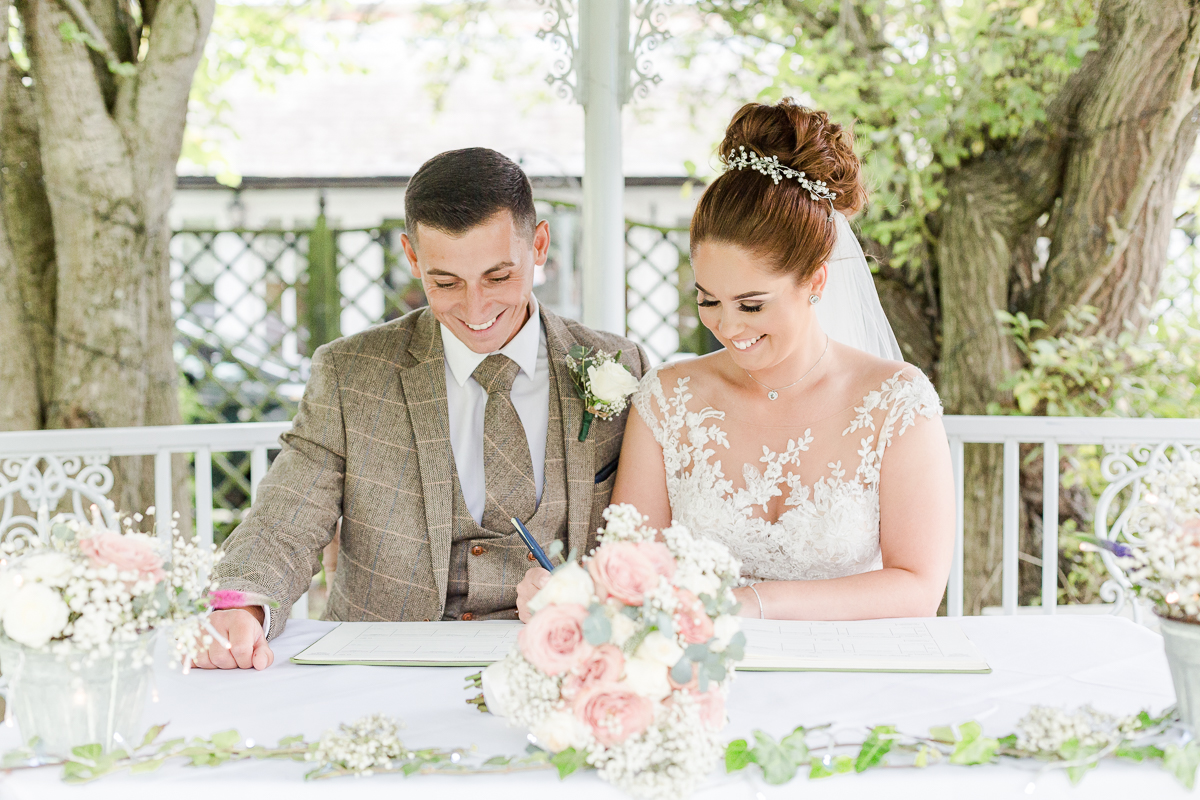 bride and groom signing register