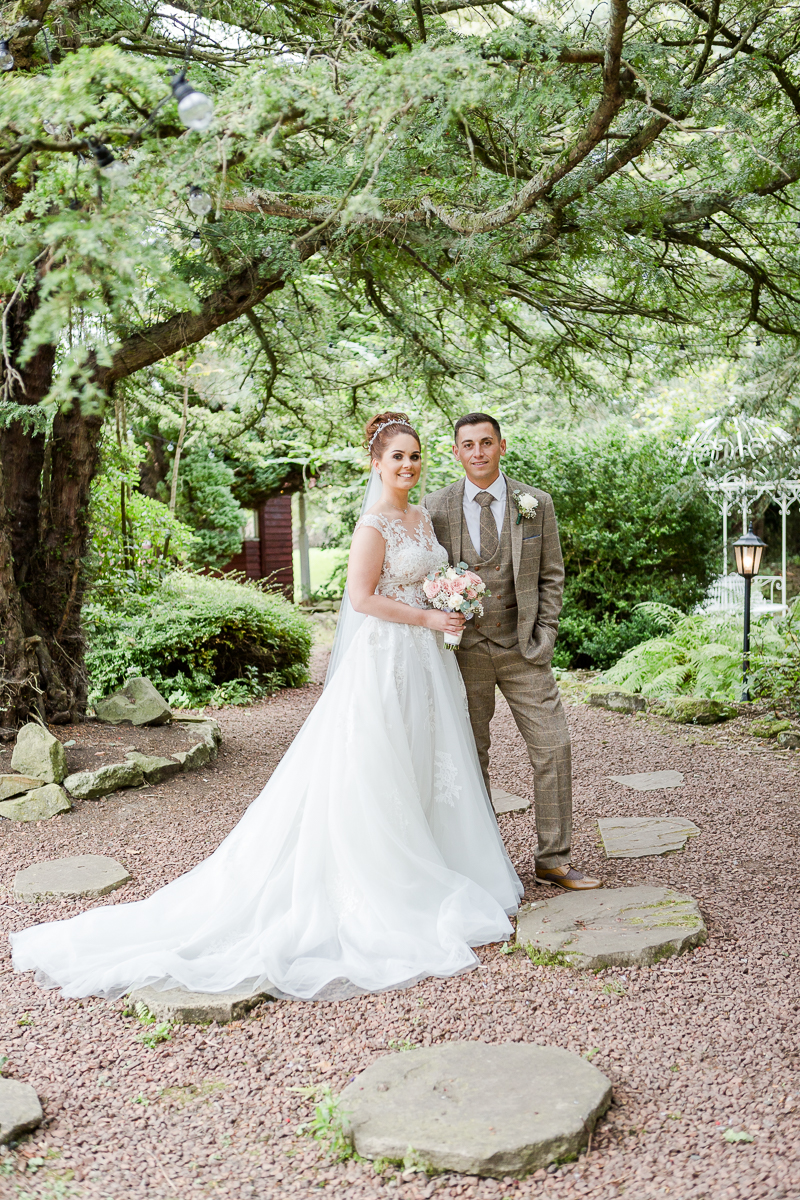 bride and groom stood together in woodland