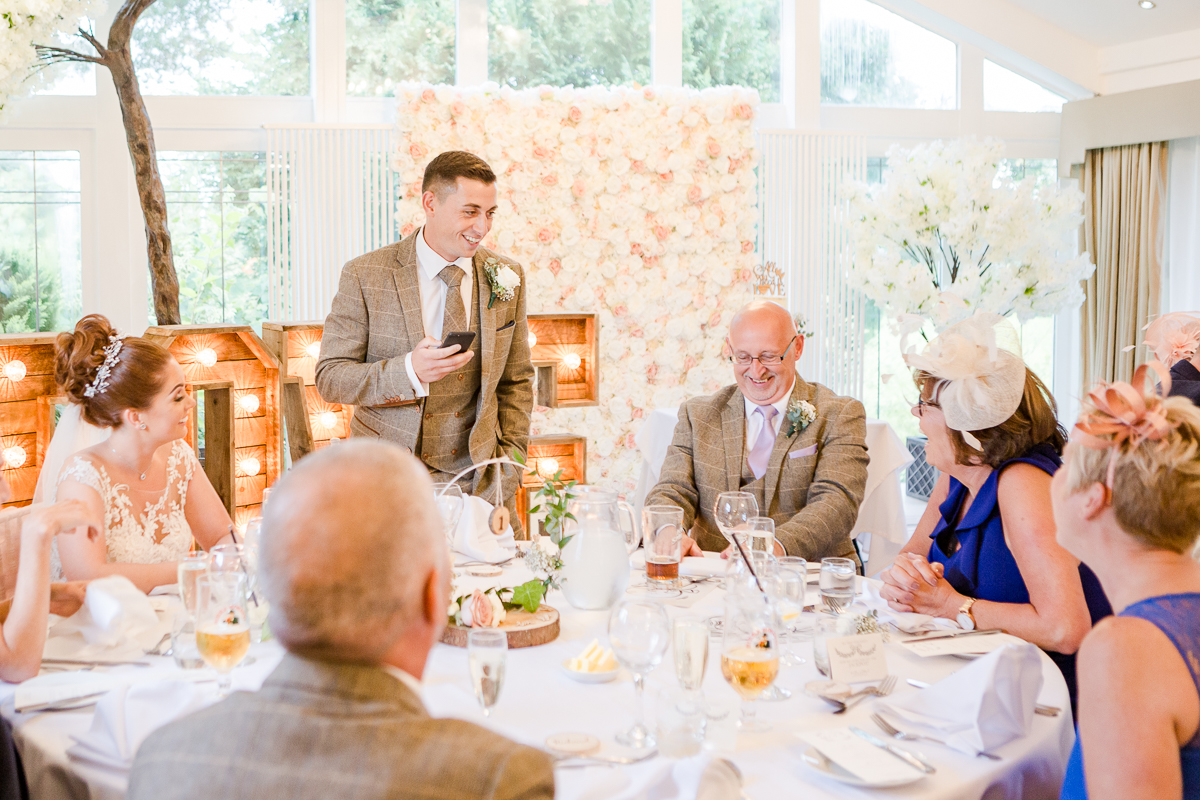 groom giving speech laughing