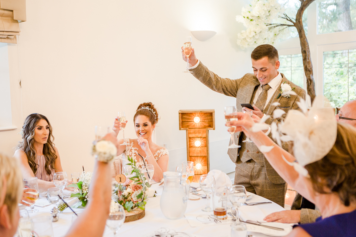 bride and groom raising a toast