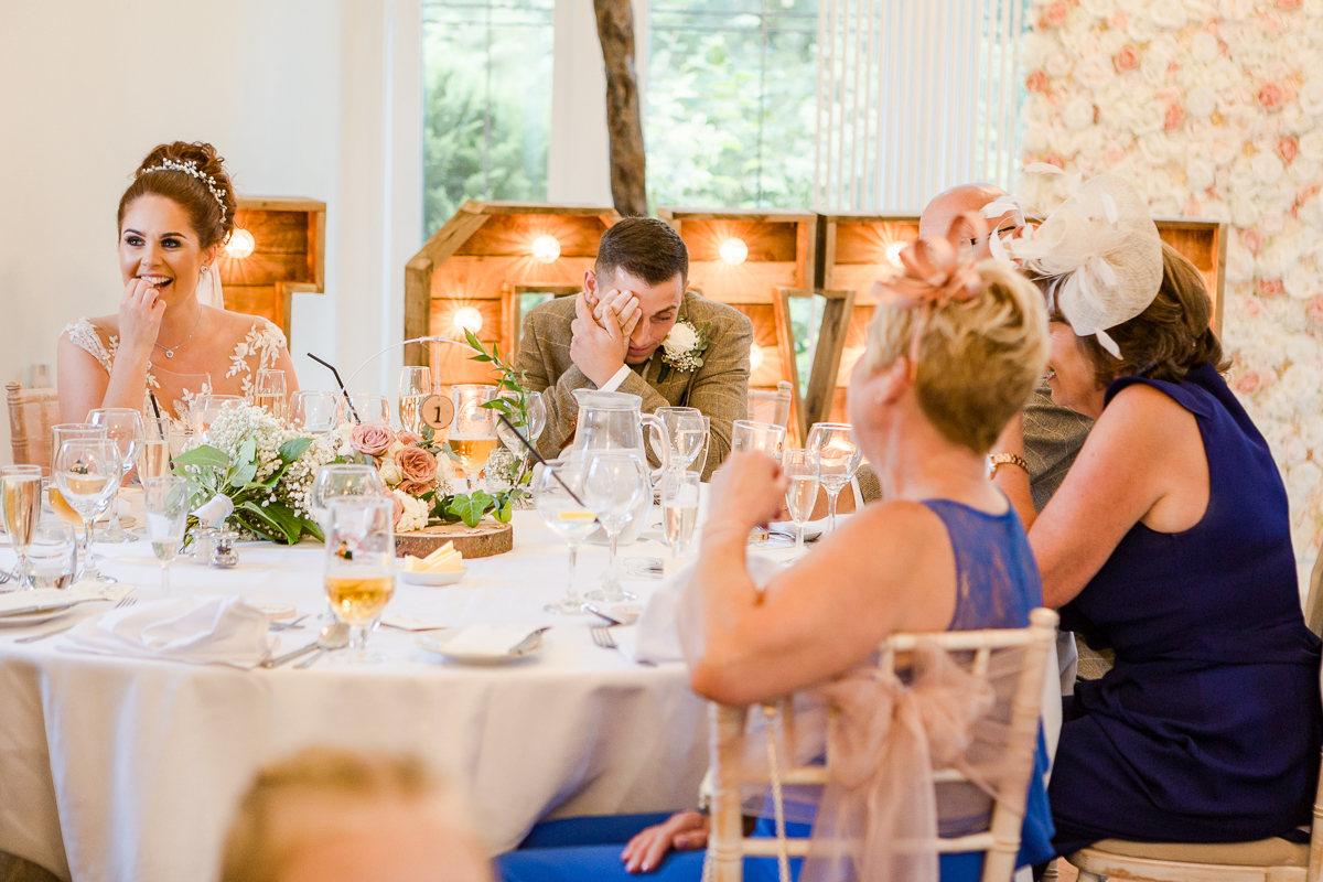 groom hiding behind hands during speech