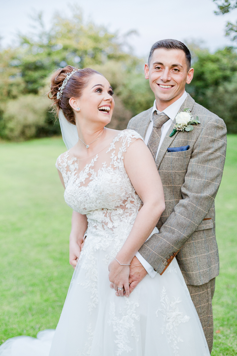 bride laughing with back to groom