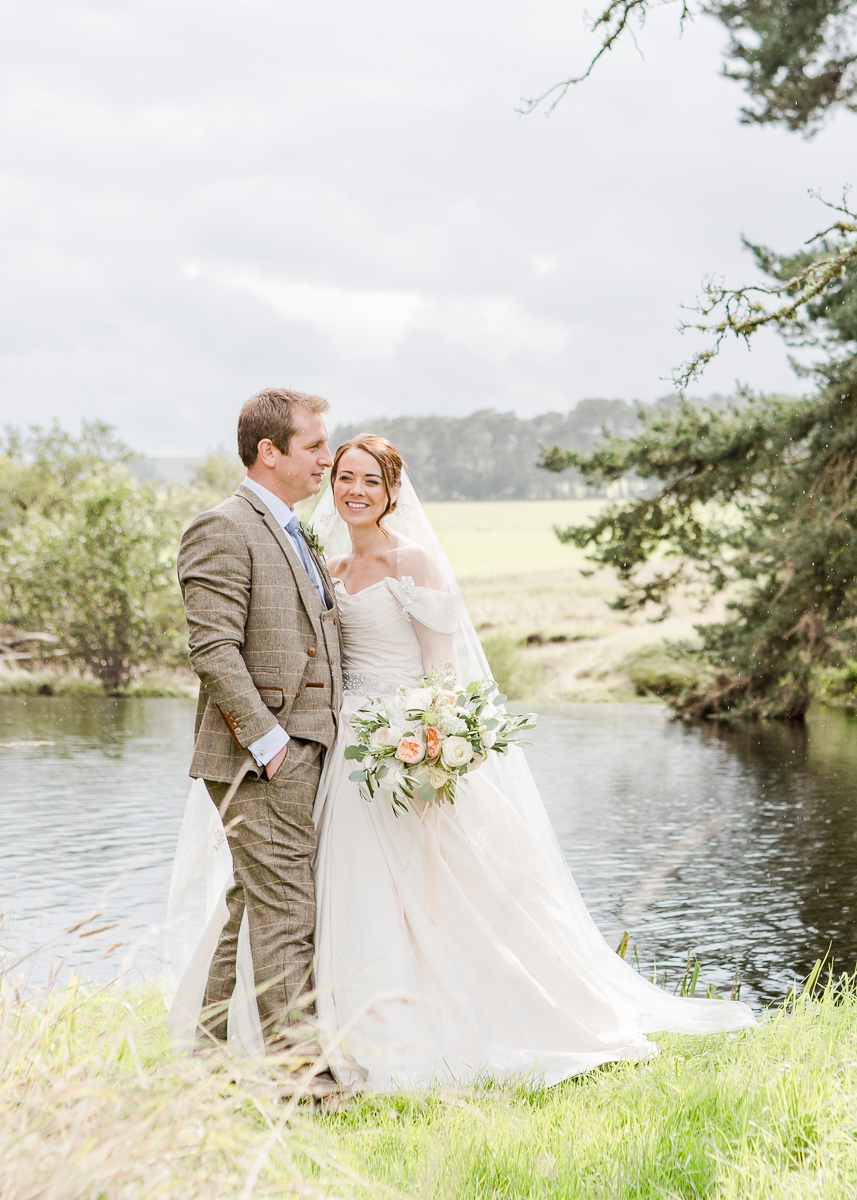 bride and groom at lake