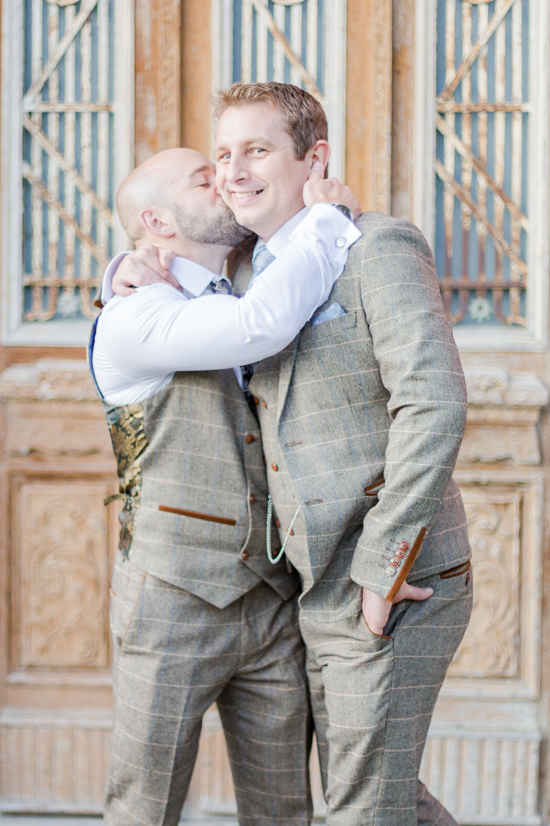 groomsman playfully kissing groom