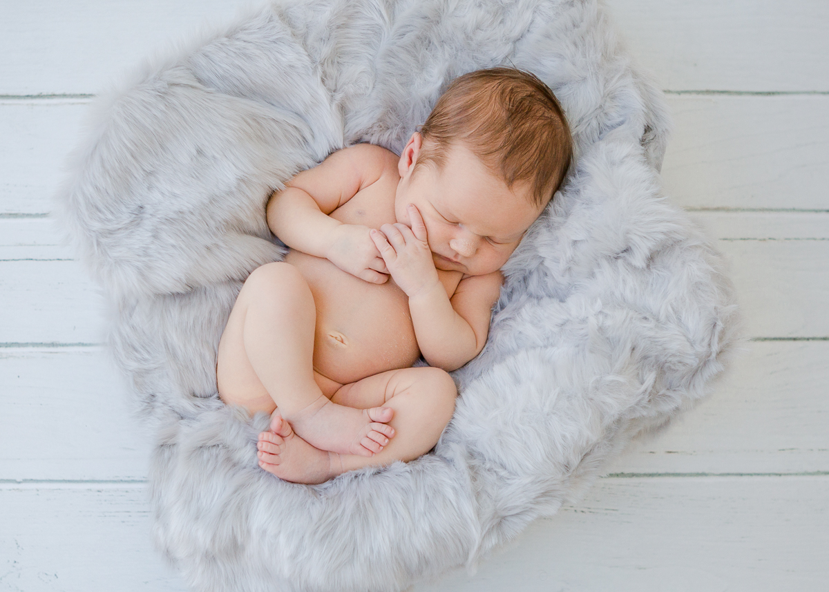 baby boy snuggled in blue fur