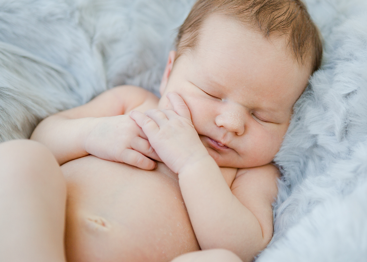 close up of baby boy snuggled in blue fur