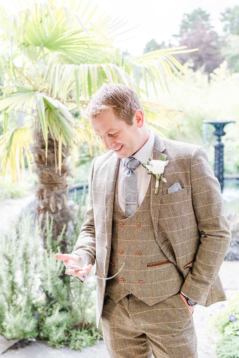 groom portrait looking at pocket watch