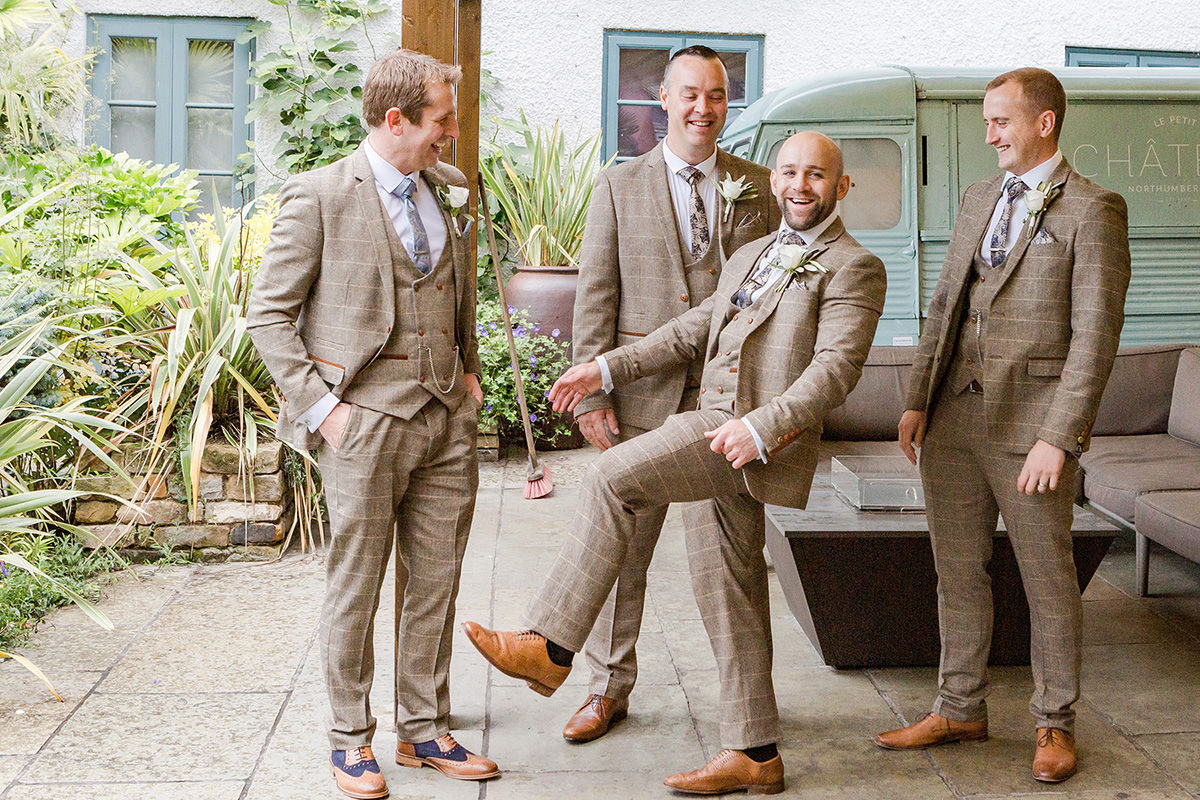 groomsmen joking around in gardens