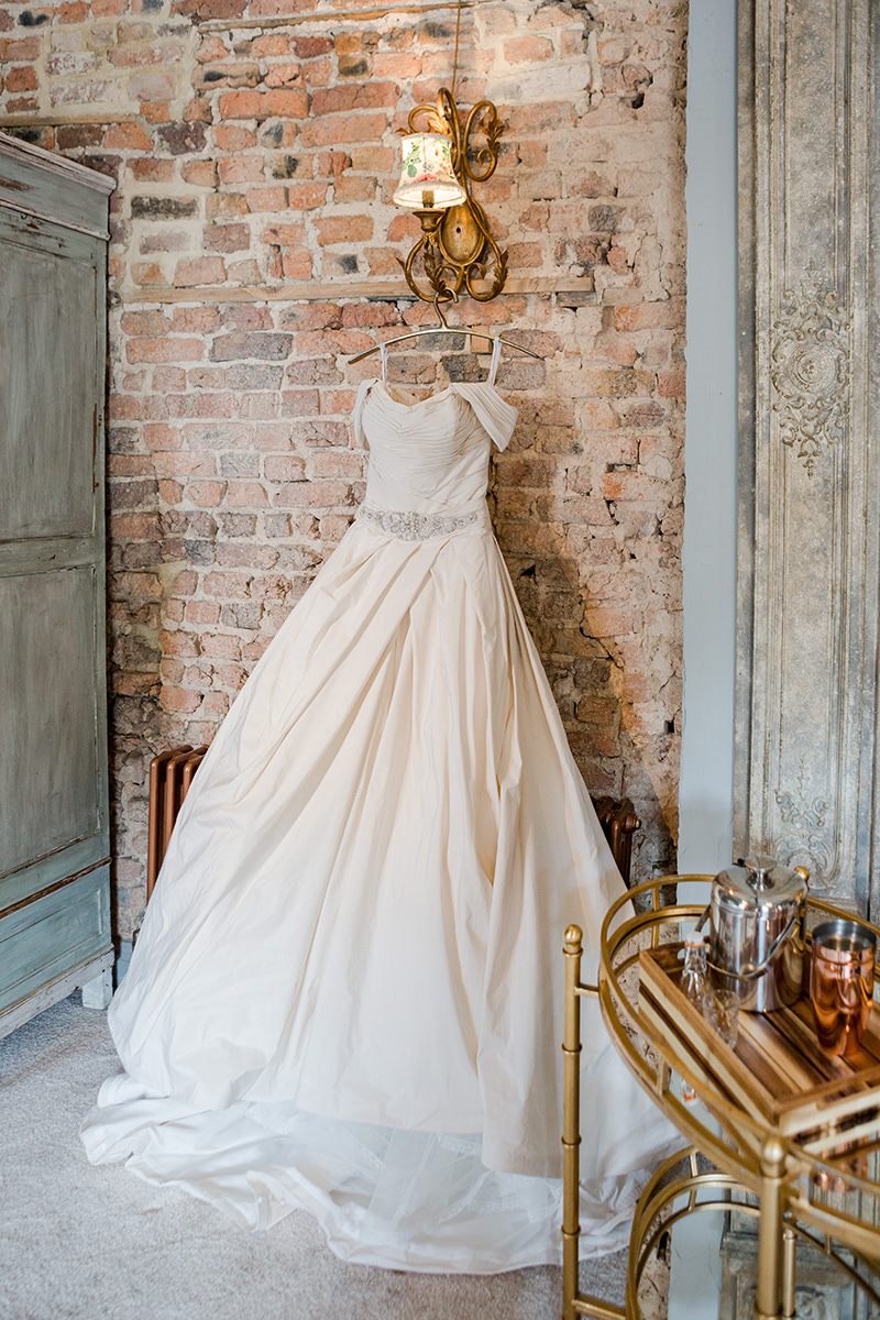 wedding gown hanging in suit