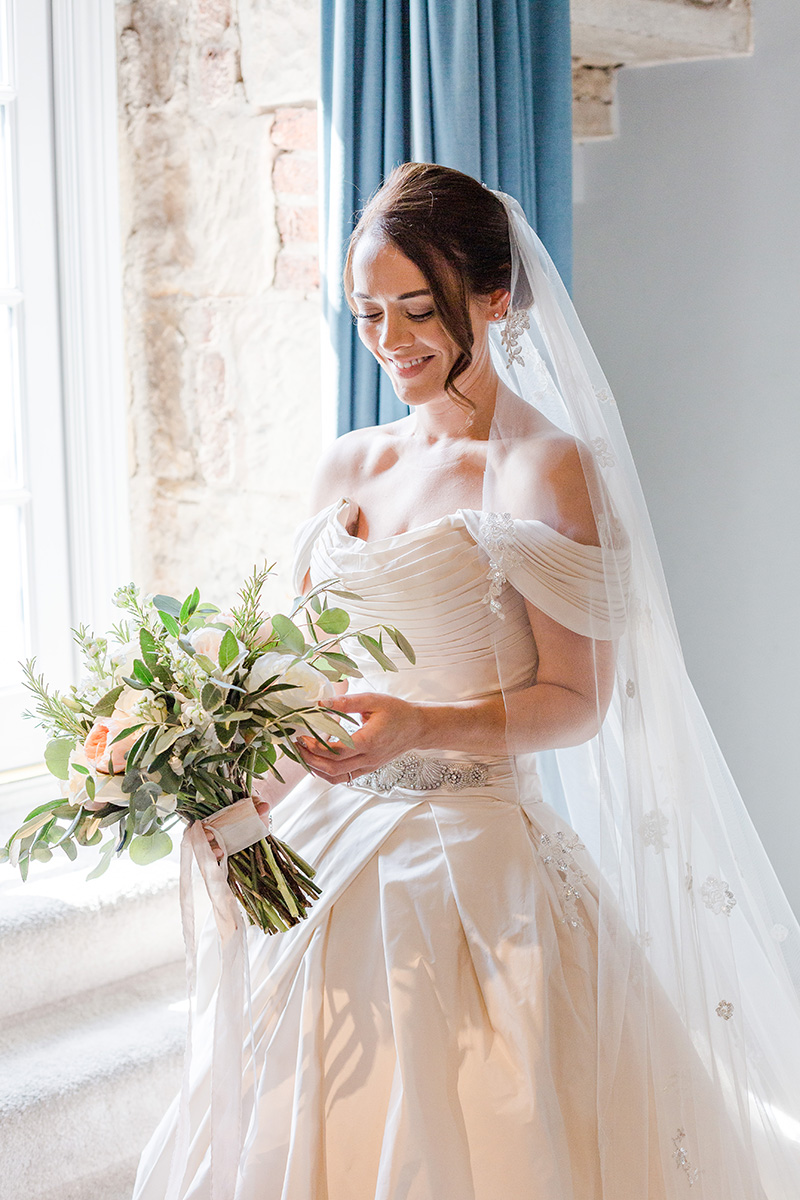 bride just ready and looking at her bouquet