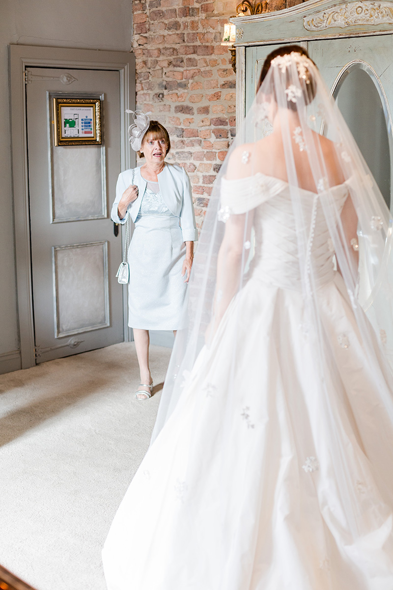 mother of bride sees daughter for the first time in gown