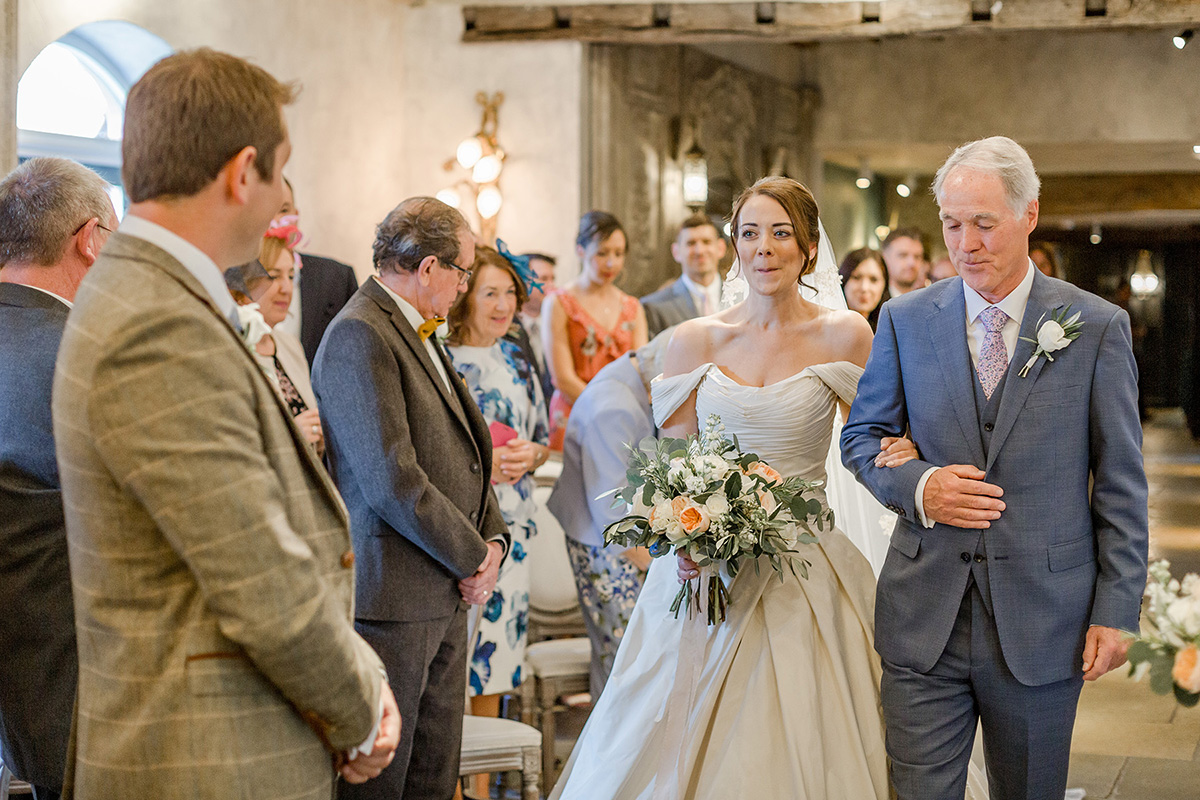 bride arrives at alter with father greeted by groom