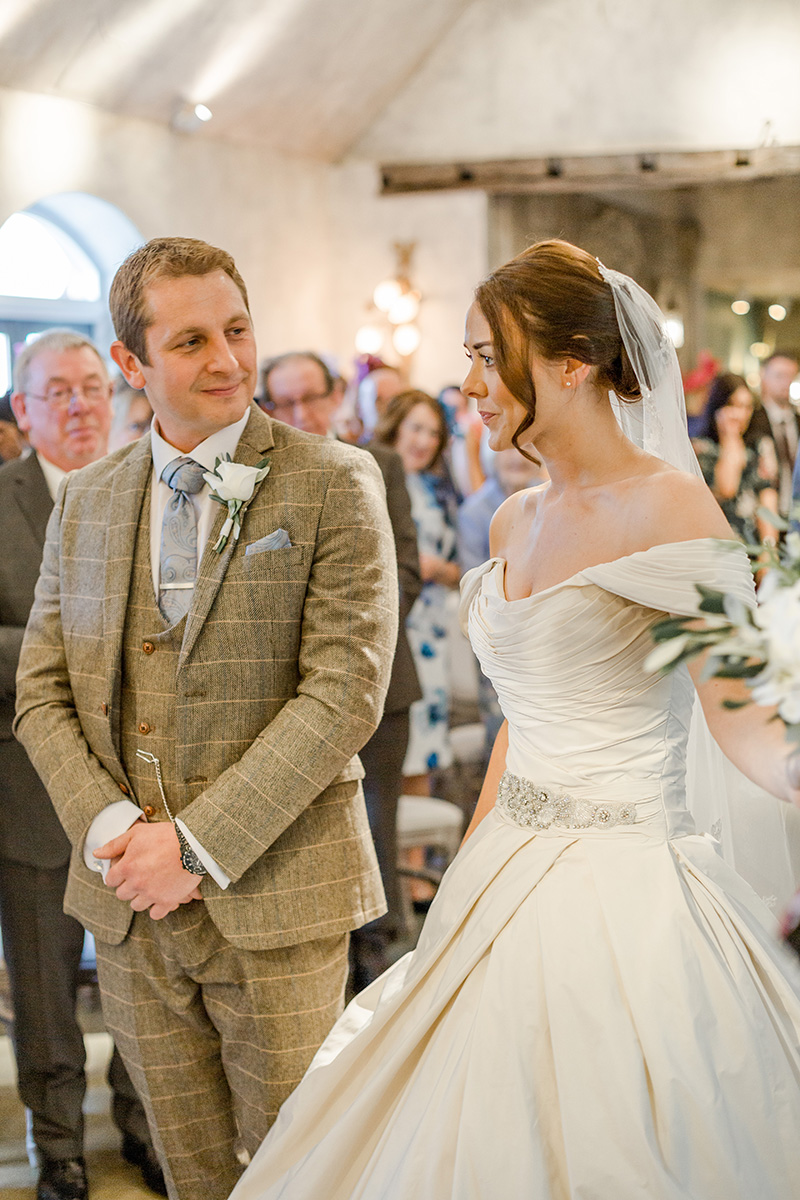 bride arrives at alter groom looks lovingly