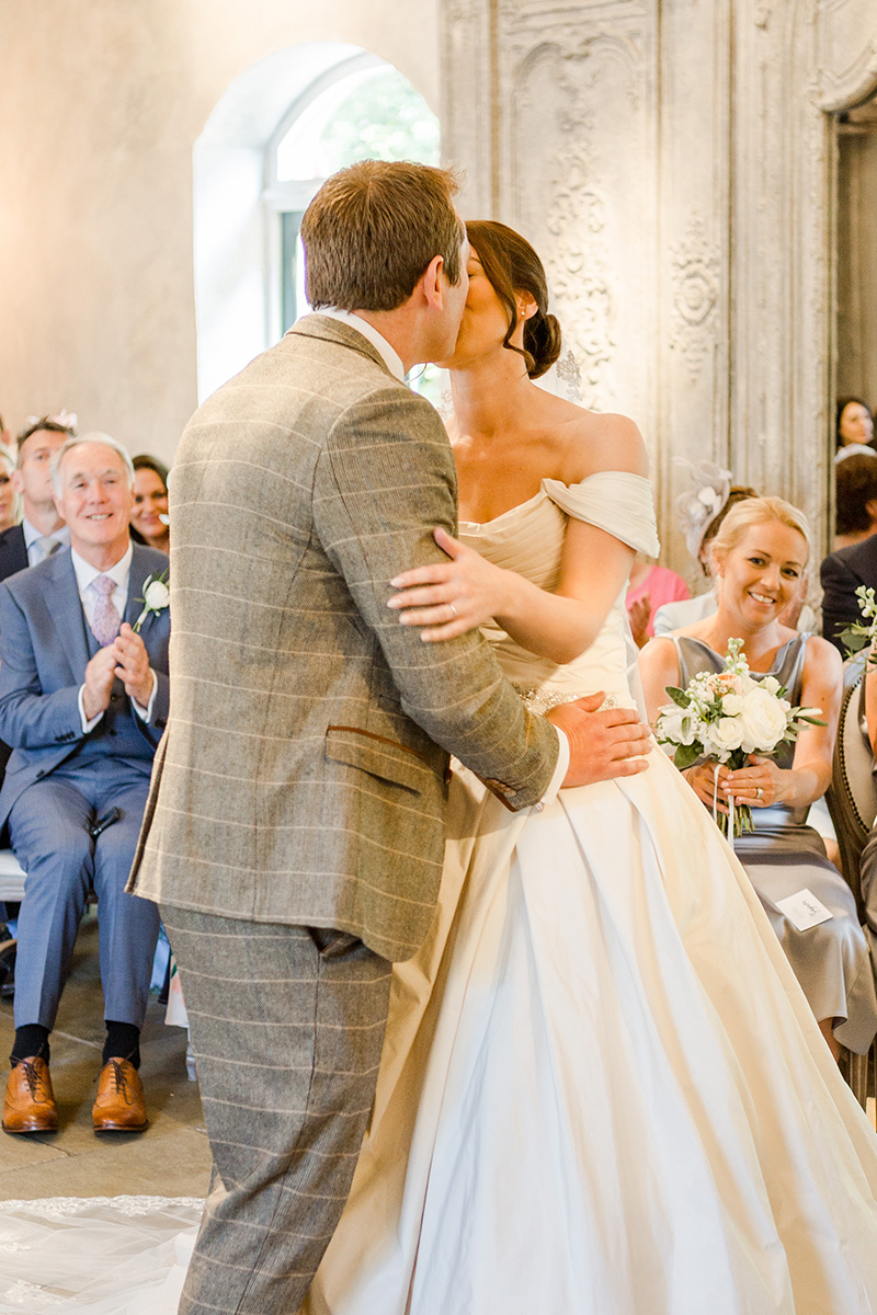 bride and groom kiss as husband and wife