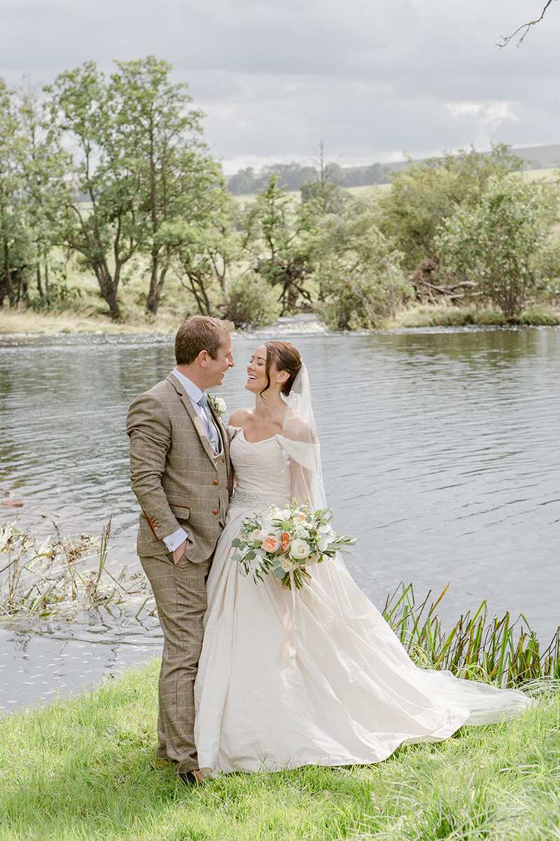 bride and groom infant of lake