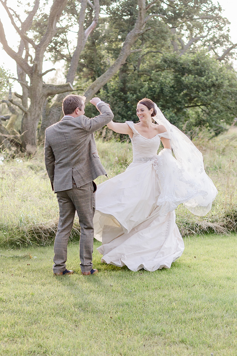 bride and groom dancing in gardens