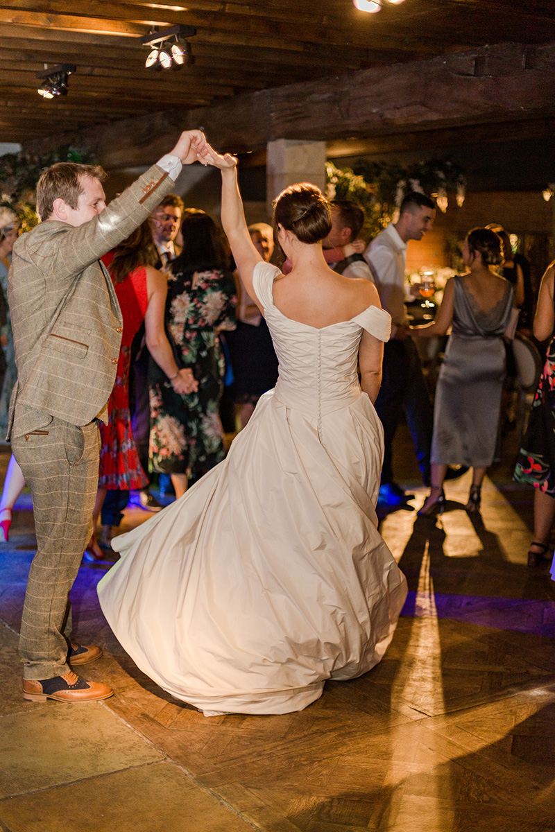 groom swirling bride in first dance