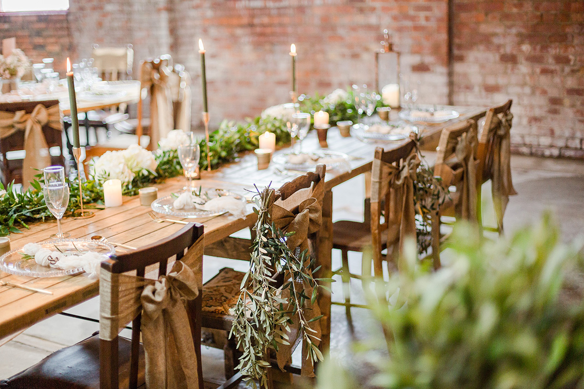 tressel table dressed with candles and herbs