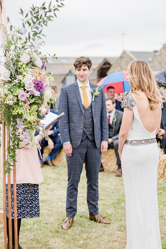 Bride and groom stood at alter in field