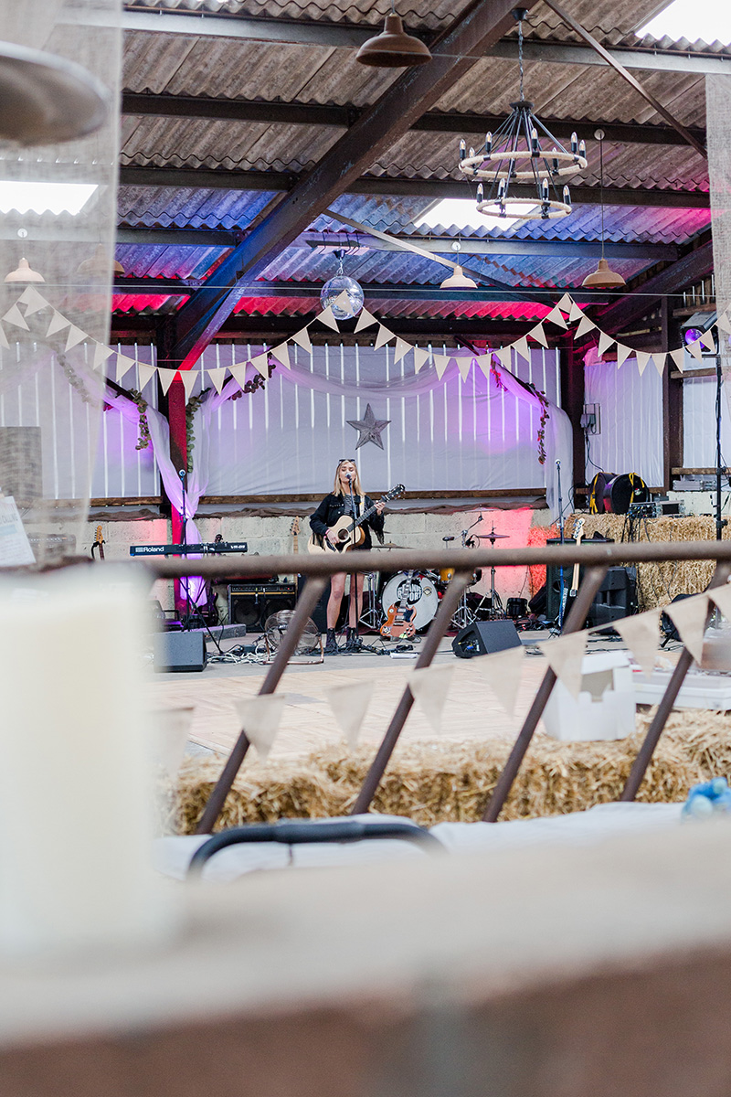 inside barn dressed with bunting and hay bales