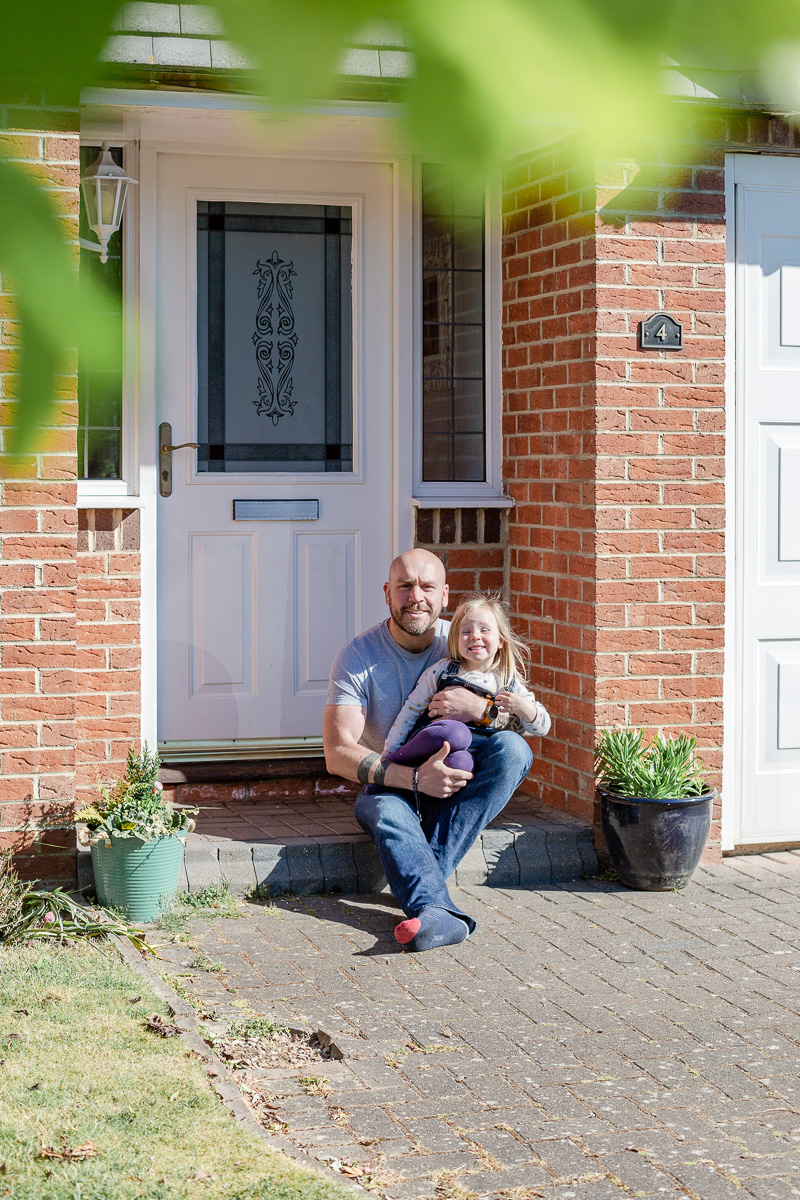 daddy and daughter sat on doorstep