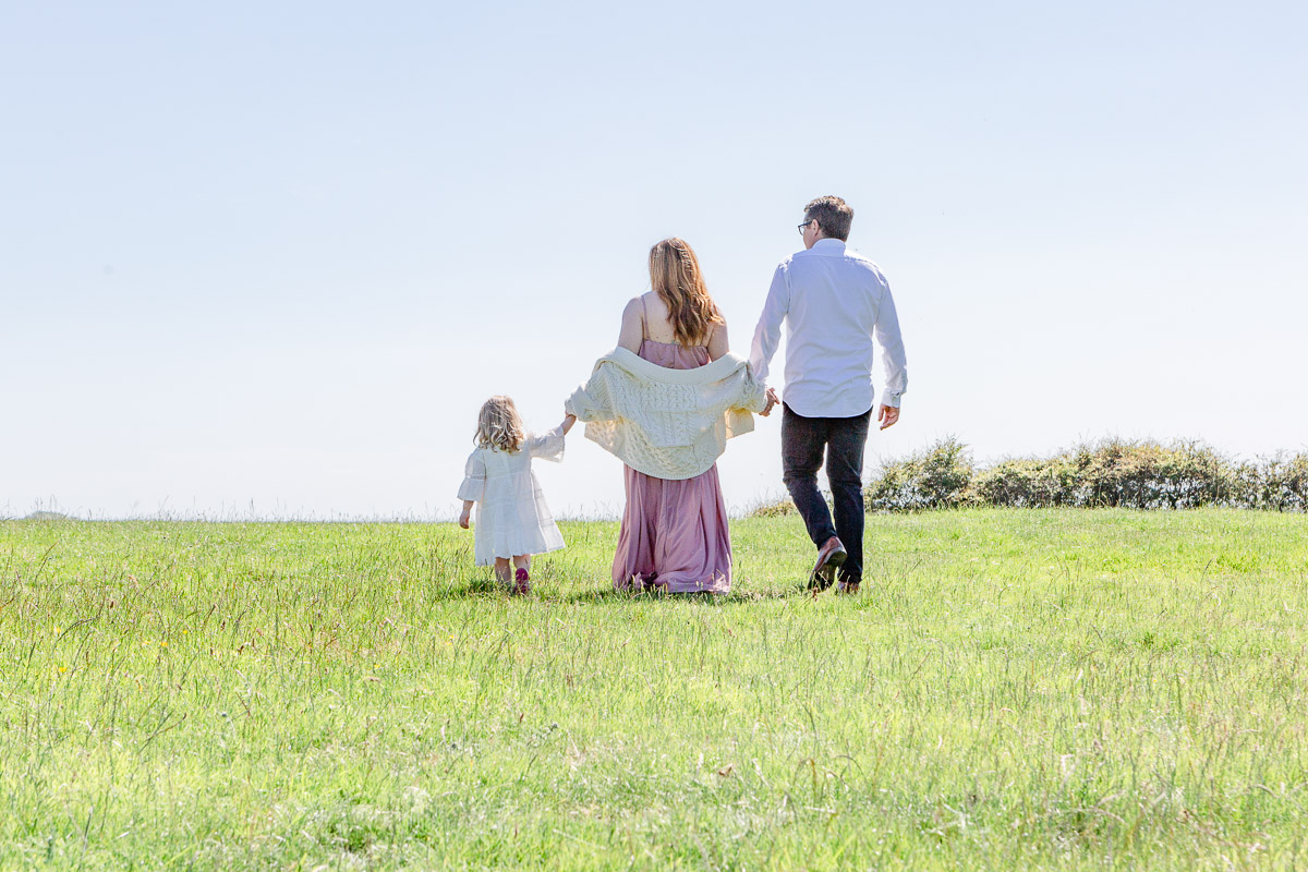 family walking away through field