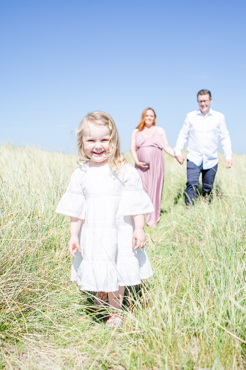 family walking through dunes