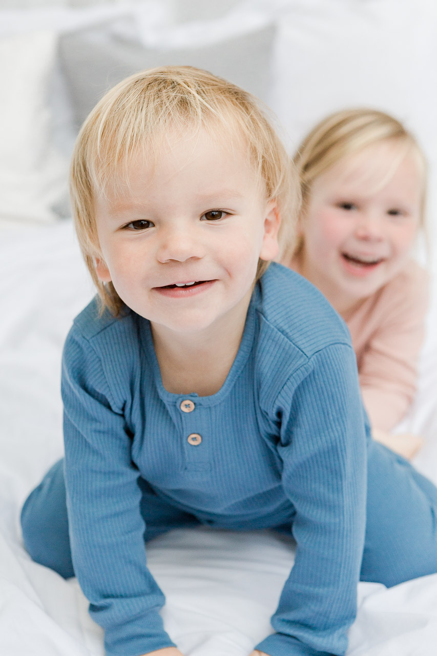 little boy close up to camera and little girl behind