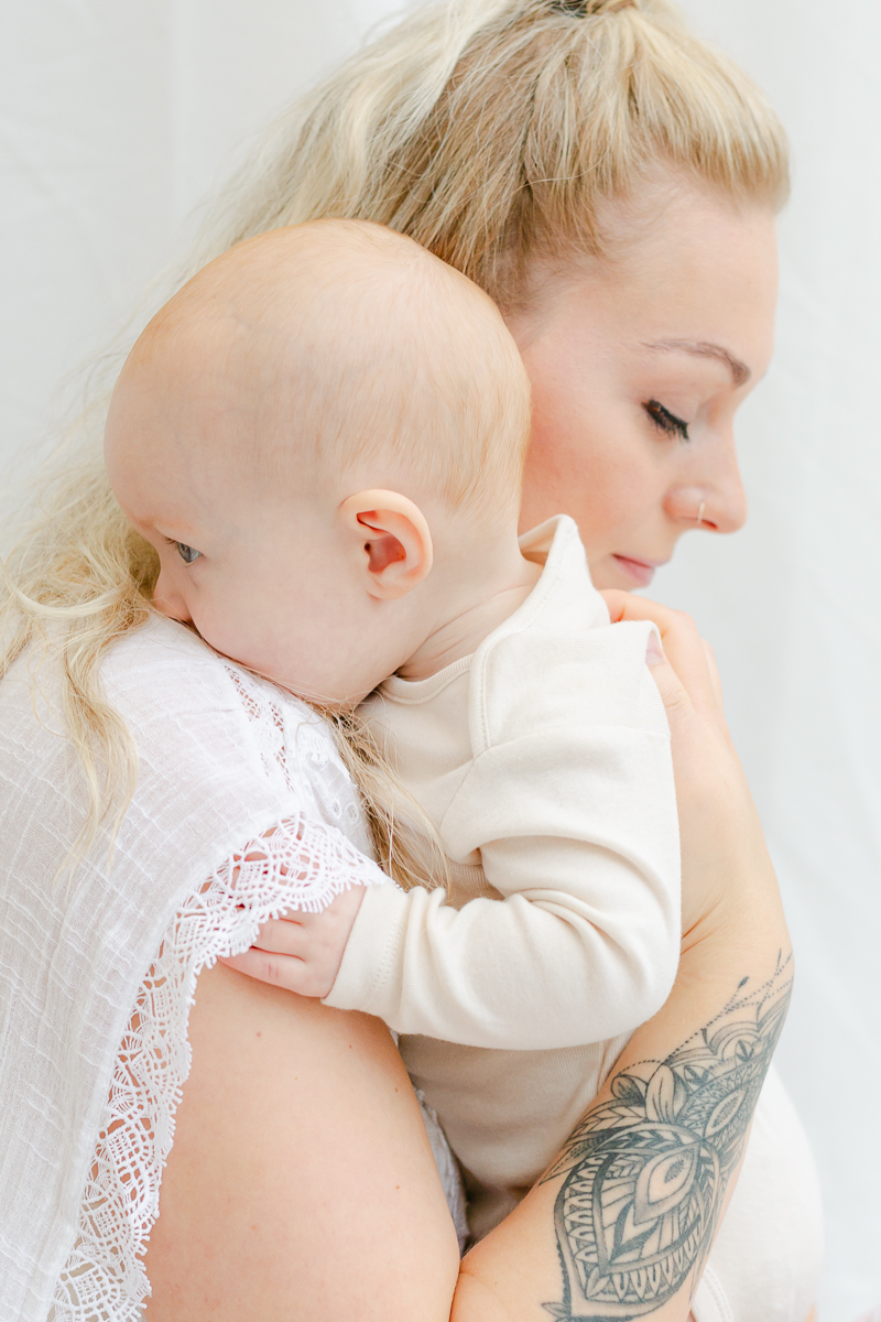 mummy and baby daughter cuddling in together