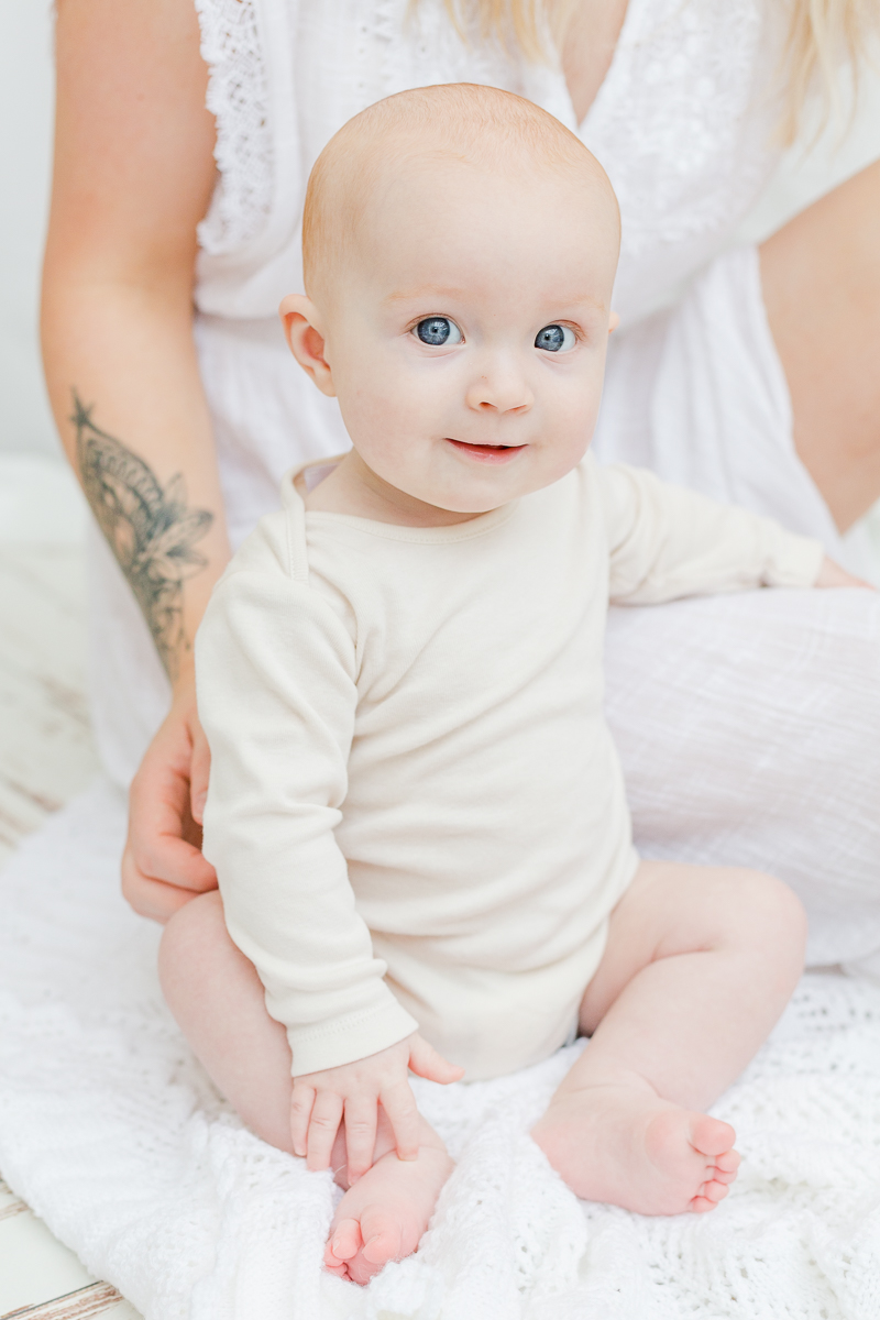 little girl in cream smiling at camera