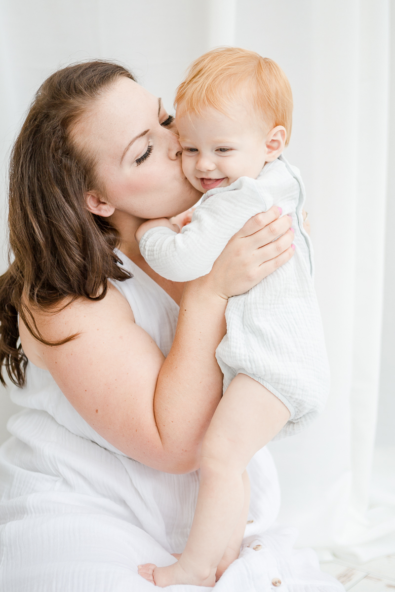 mummy and me photography session mummy kissing daughters face