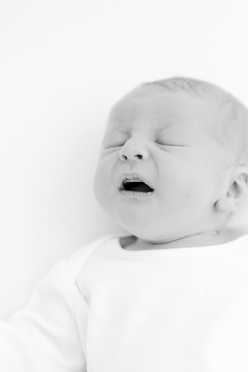 black and white photo of baby about to sneeze