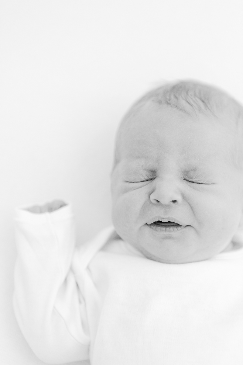 black and white photo of baby sneezing