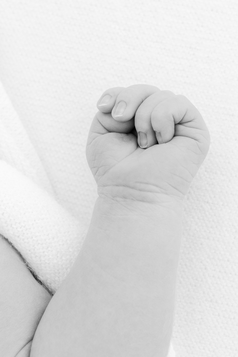 black and white close up of newborn baby hand