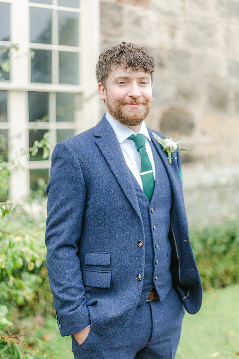 Groom smiling wearing suit