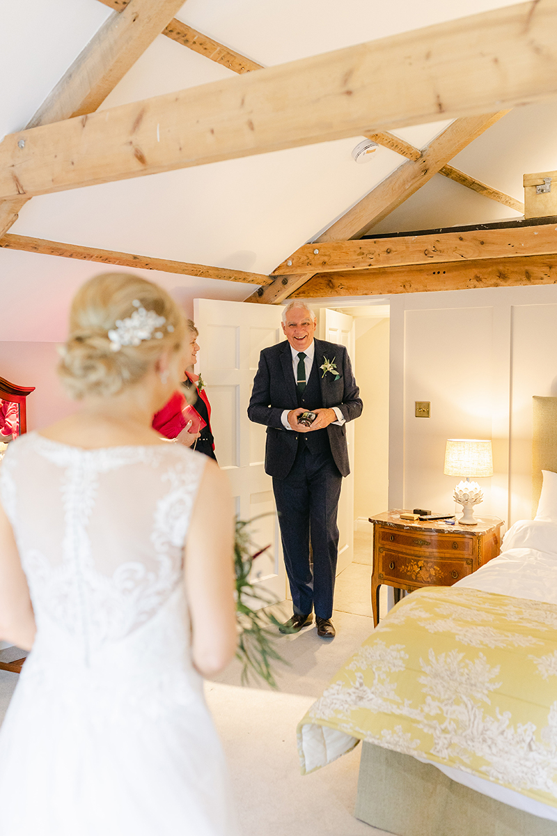 father of the bride entering room to see daughter