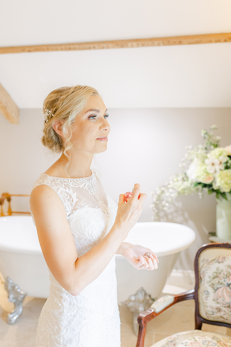 bride spraying perfume