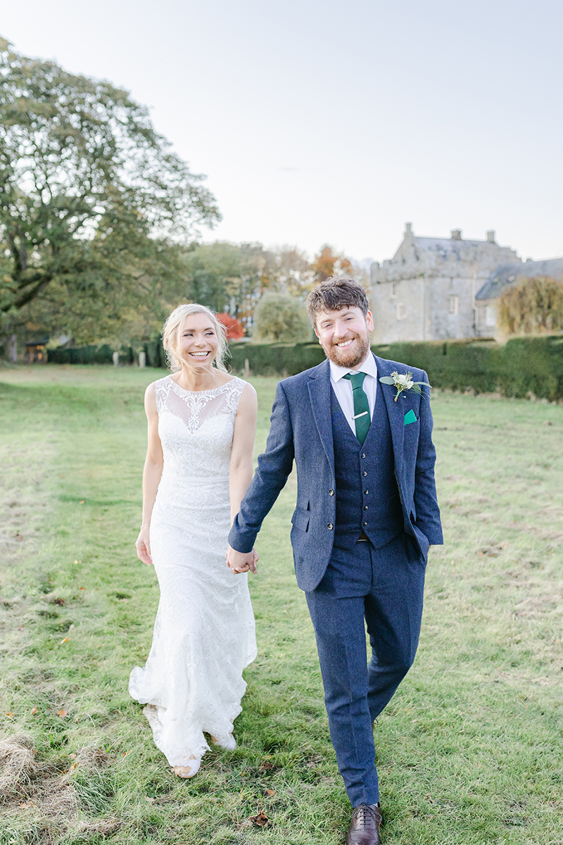 groom pulling bride along both laughing