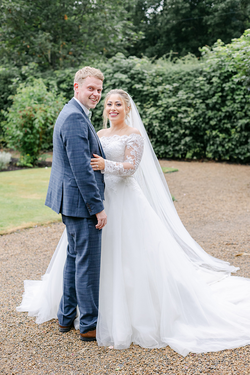 Bride and groom twisting towards camera smiling