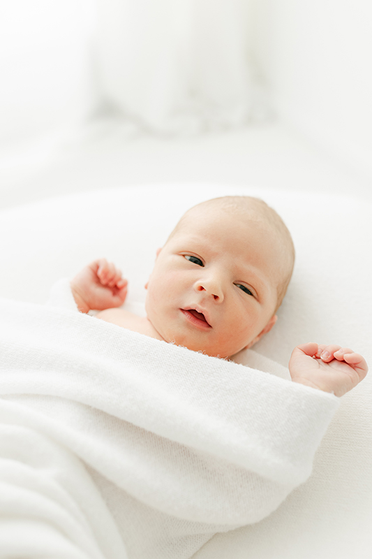 newborn baby wrapped in white