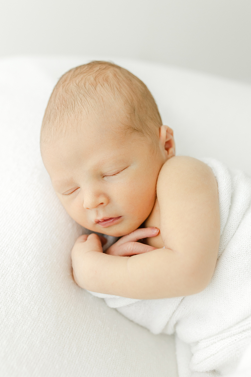 newborn baby asleep on side