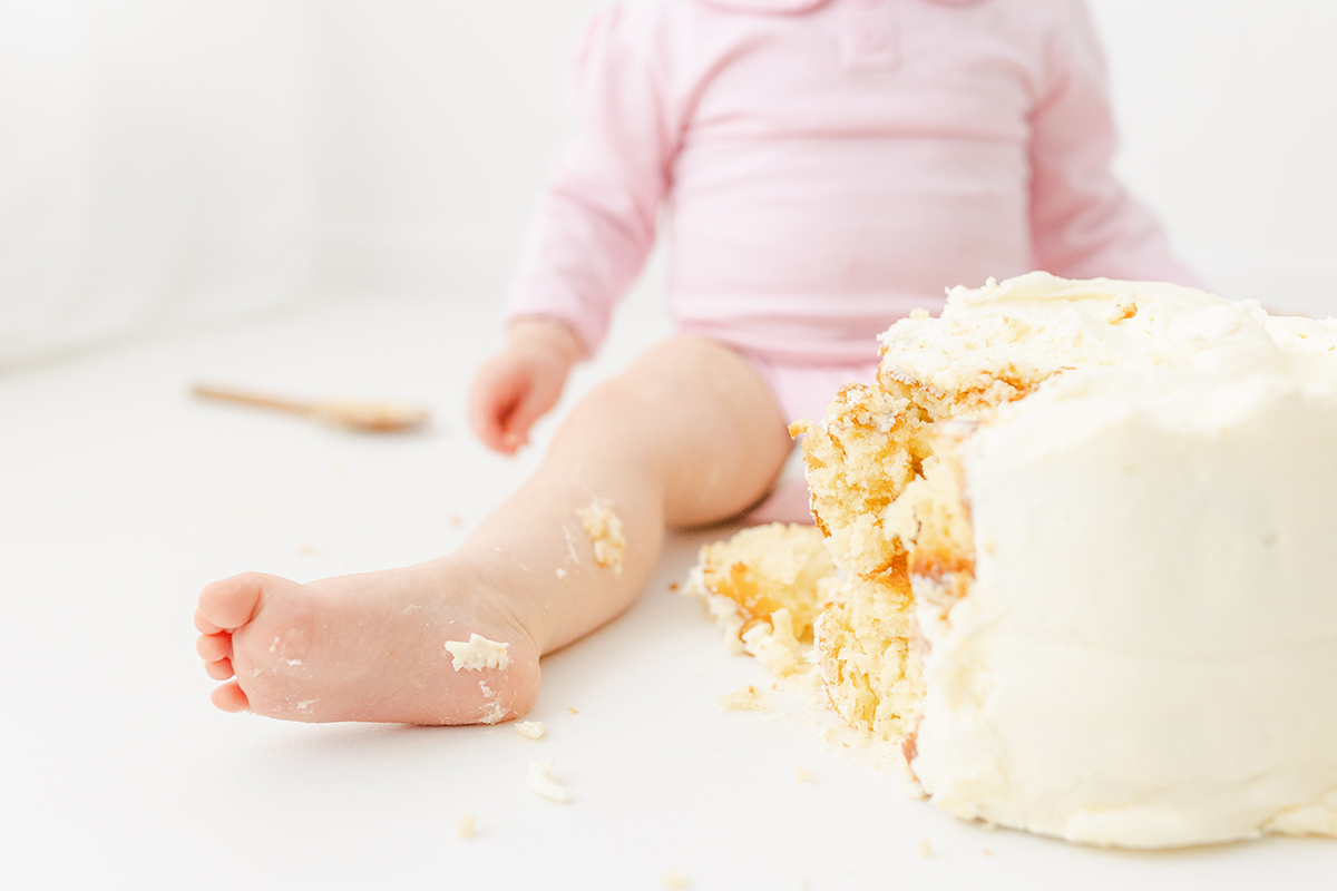 little girls foot with birthday cake smashed